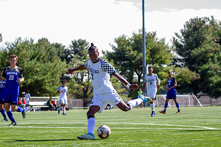 Eiichi Yamaguchi shoots the ball against Carroll College